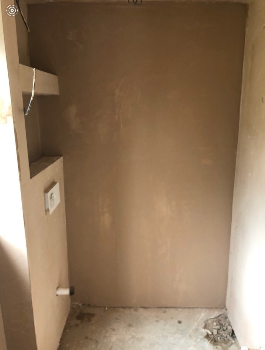 A newly plastered alcove, smooth and drying out