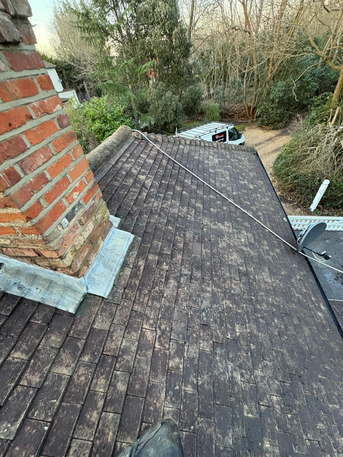 A cleared roof beside the chimney stack